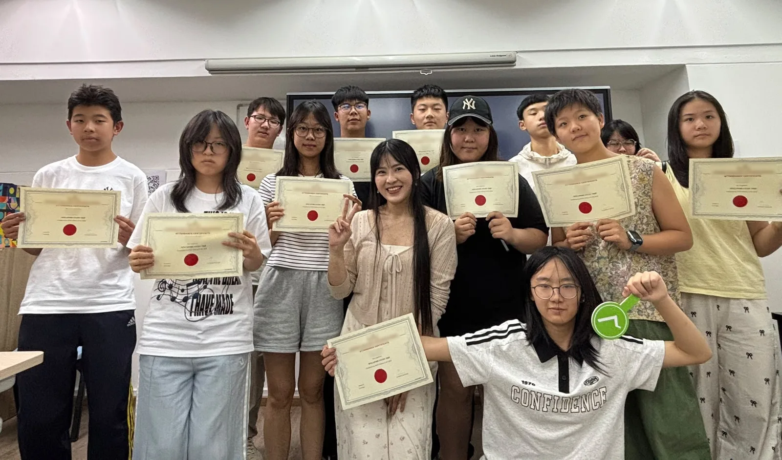 Miss Melissa with a class of students holding their certificates