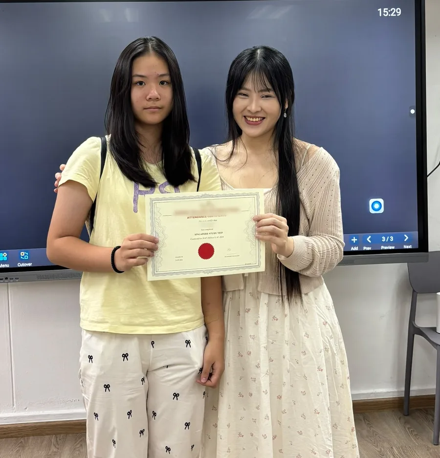 Miss Melissa with a student holding her certificate
